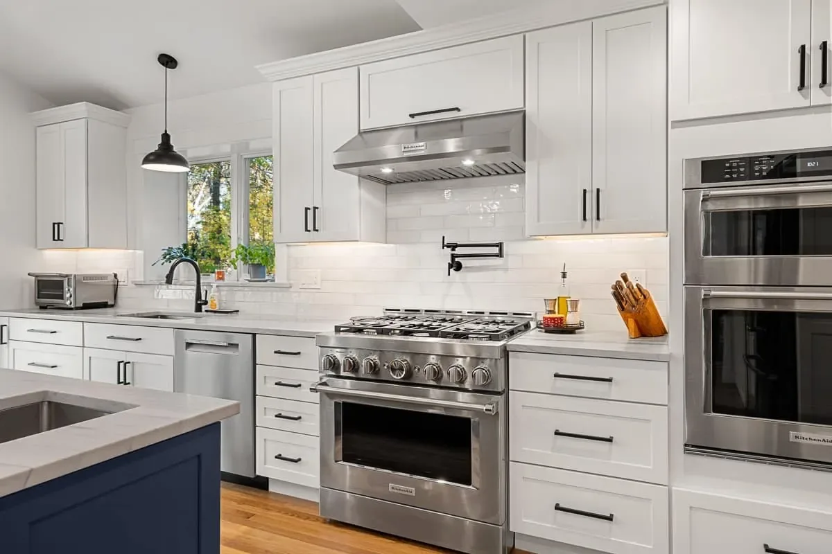 Professional gas range, pot filler and double wall ovens in a kitchen addition, Andover MA