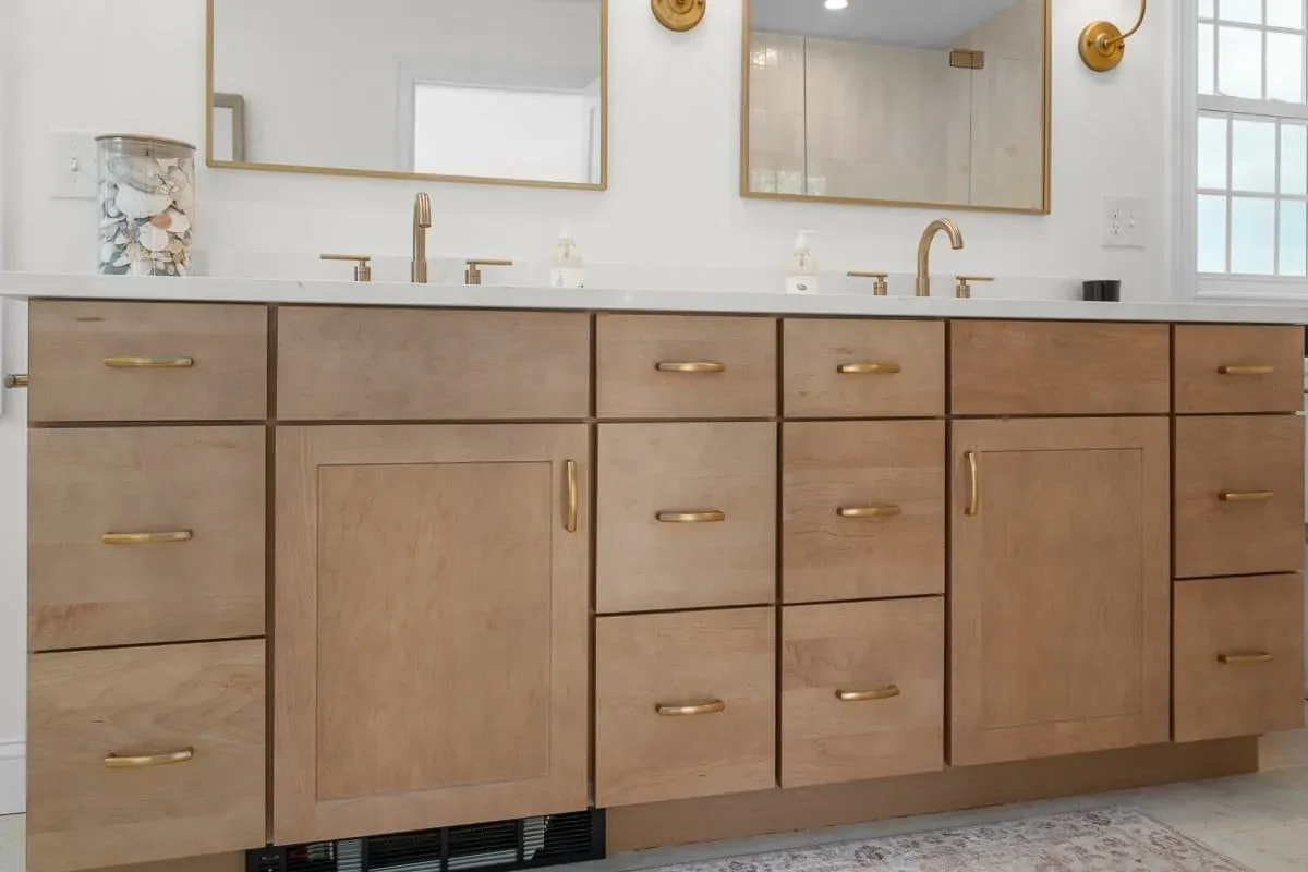 Custom maple double vanity with quartz top and brushed brass faucets