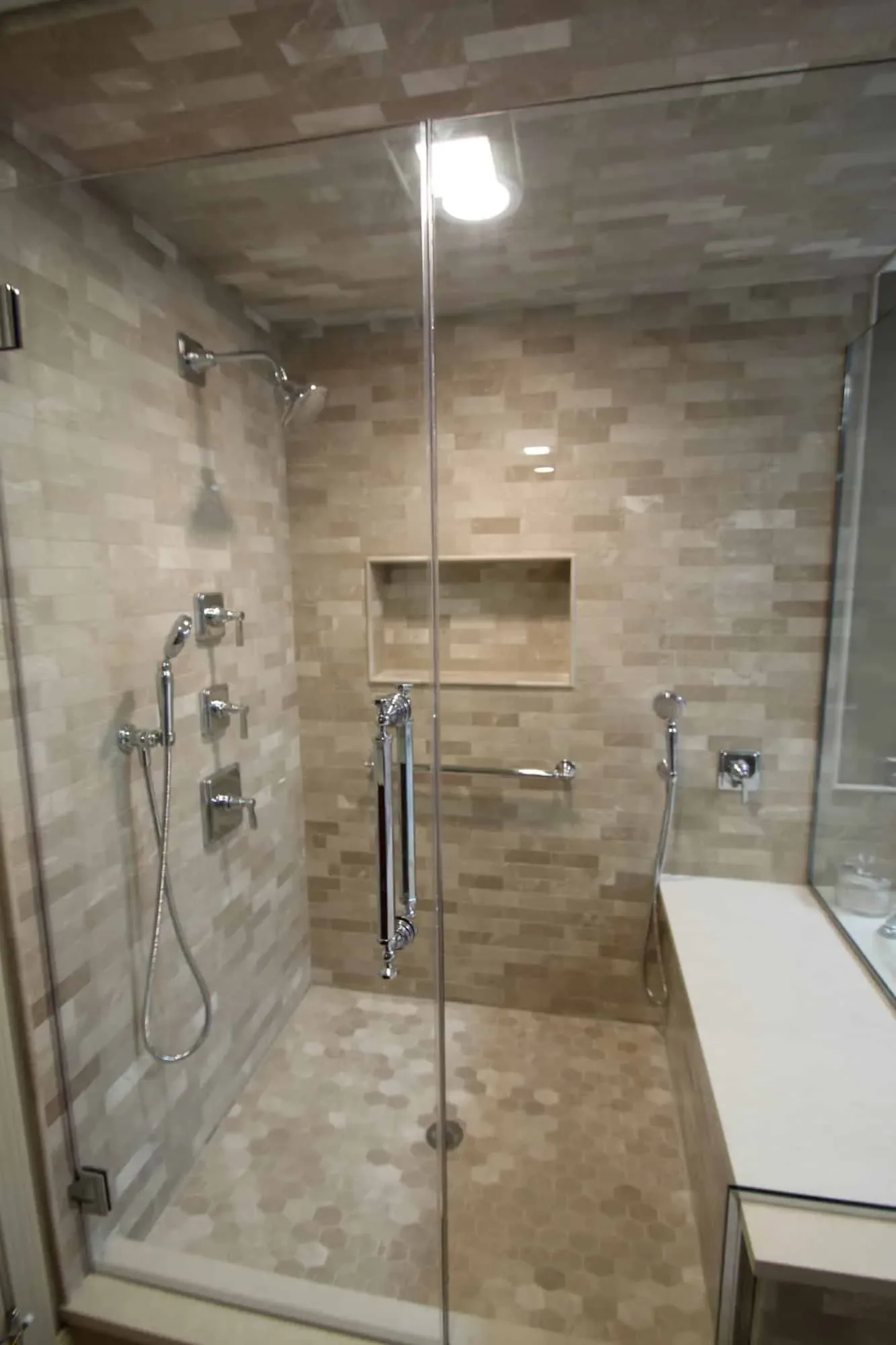 Inside the walk-in shower with stone tile on the walls and ceiling, Byfield MA