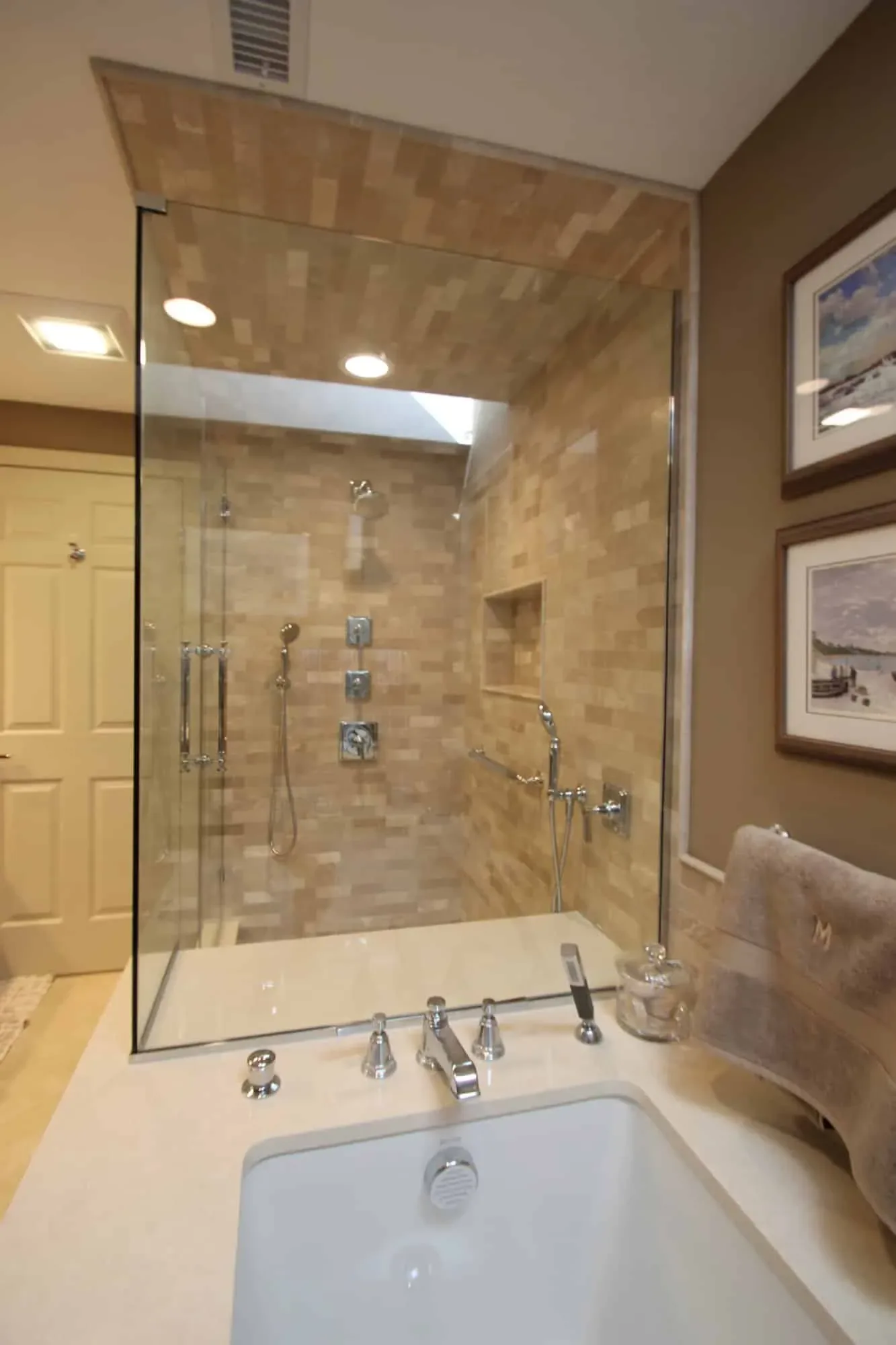 View over the soaking tub into the stone-tiled glass shower, Byfield MA