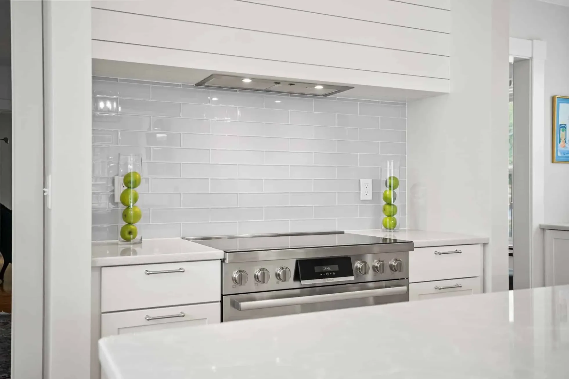 Shiplap hood surround over the induction range with full-height subway tile