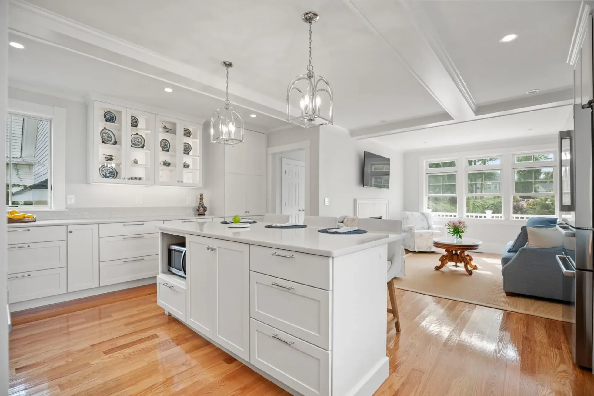 Kitchen island open to the living room and windows beyond