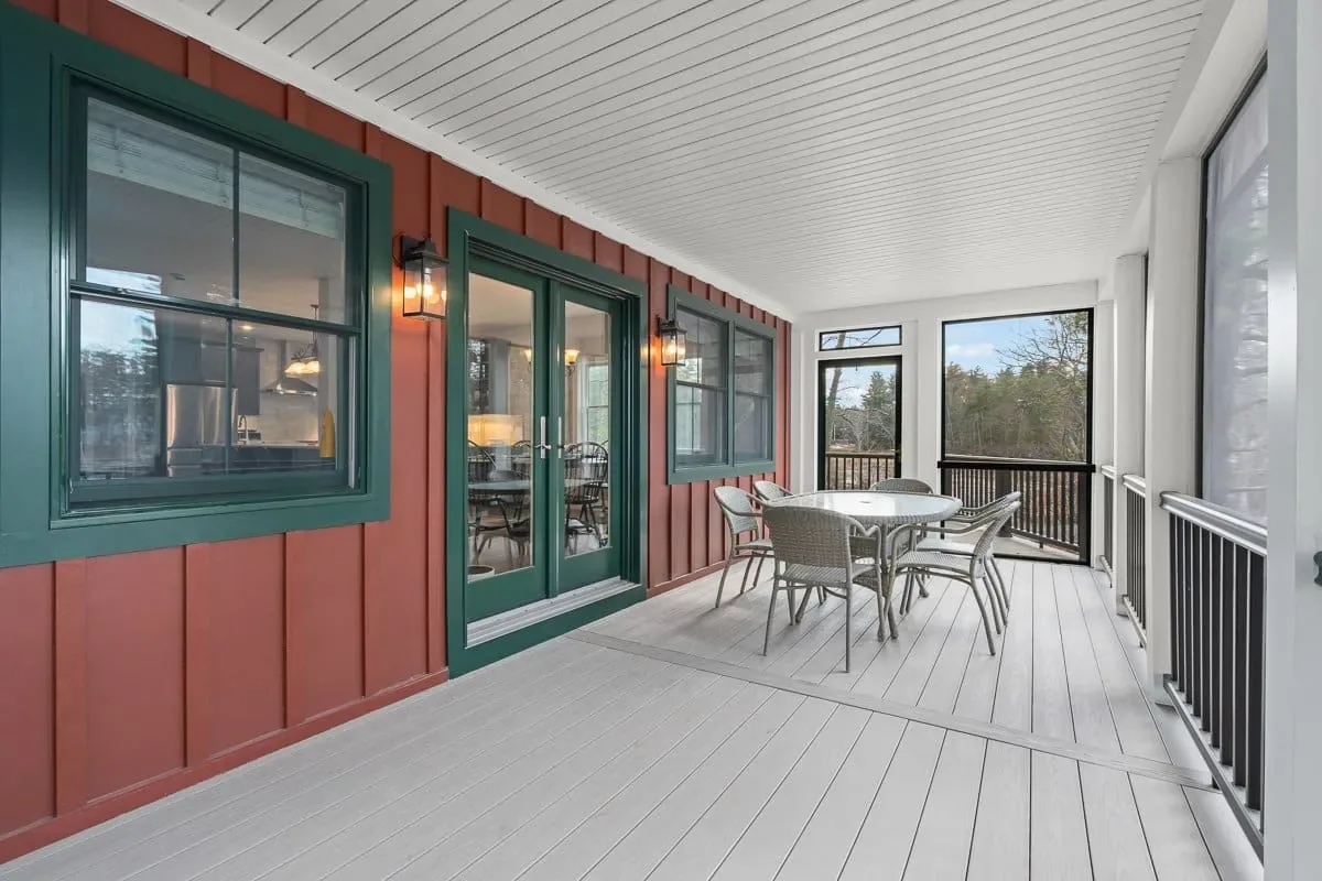 Screened porch with composite decking, board-and-batten siding and glass doors