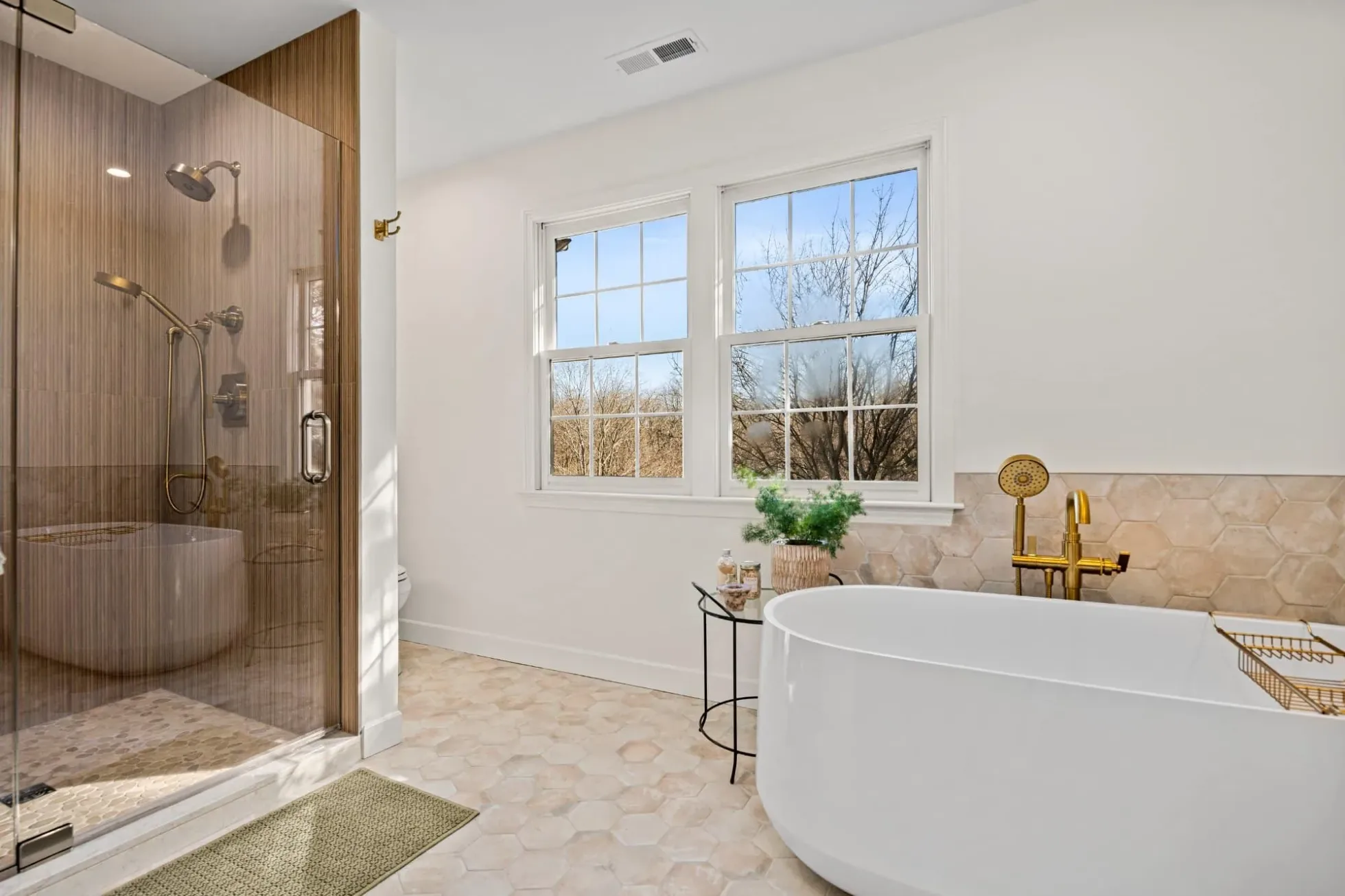 Walk-in shower with floor-to-ceiling textured porcelain behind frameless glass
