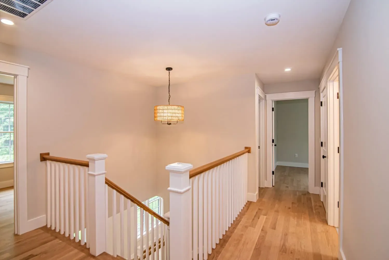 Upstairs landing with a stained oak handrail and white balusters, Newton NH